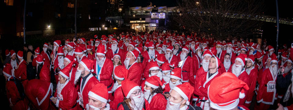 Crowd of people wearing Santa suits at Santa in the City